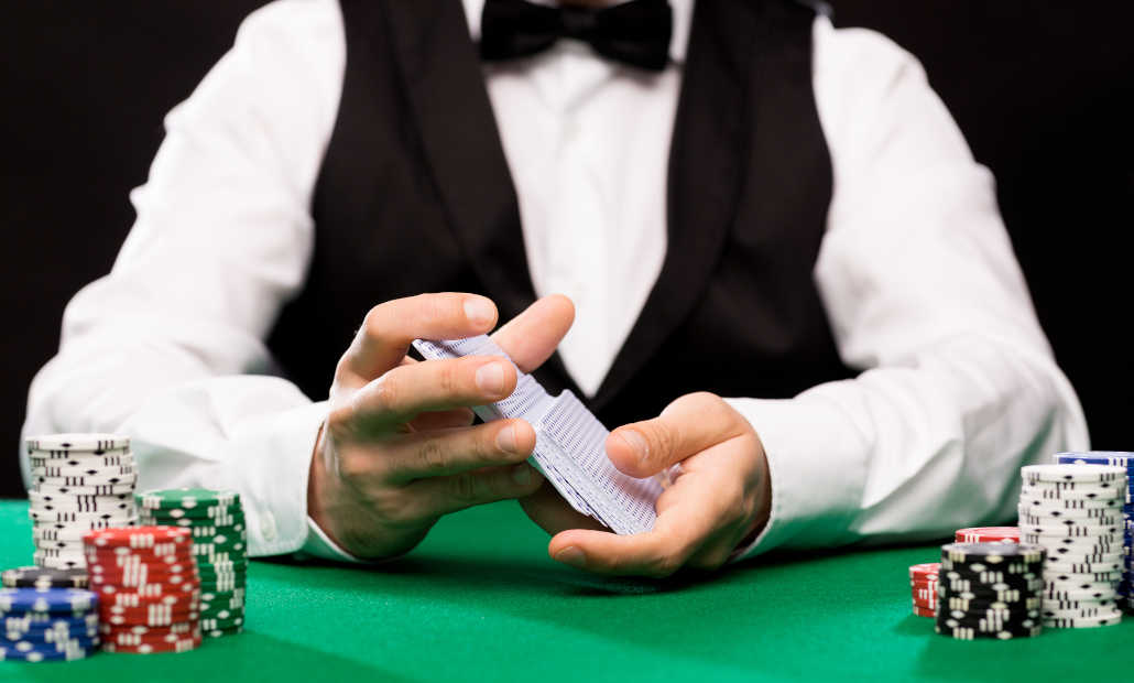 Dealer dealing cards at a Casino Hold'em table.