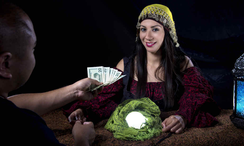 A person on the phone, looking concerned, representing reporting a scam.