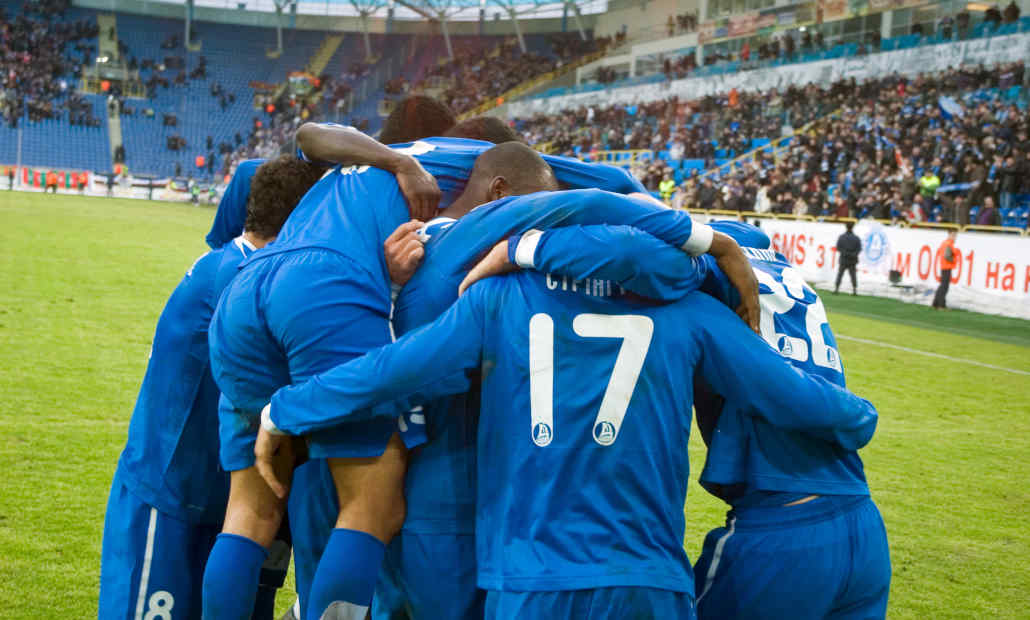 A football with gambling logos in the background