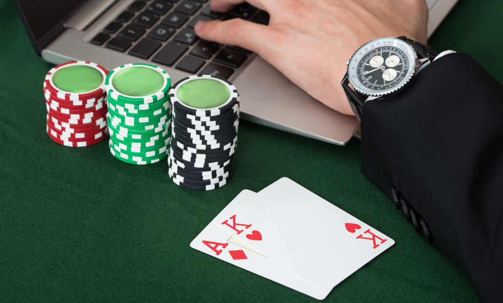 A poker player multi-tabling on multiple computer screens.