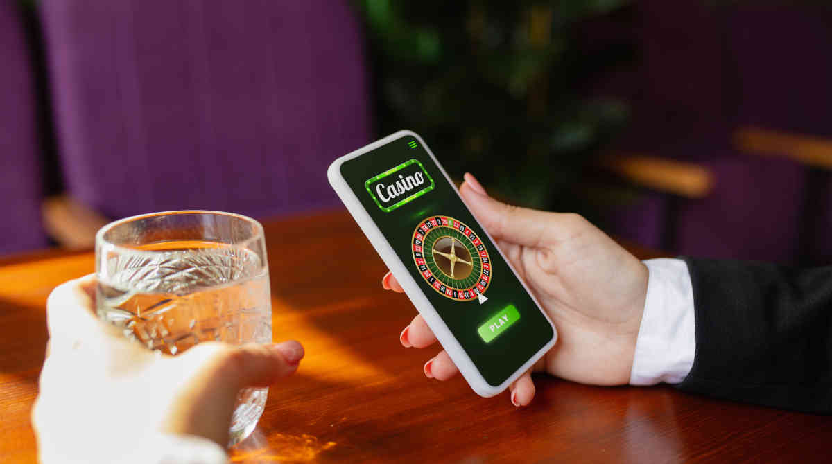 A person using a smartphone to play online casino games.