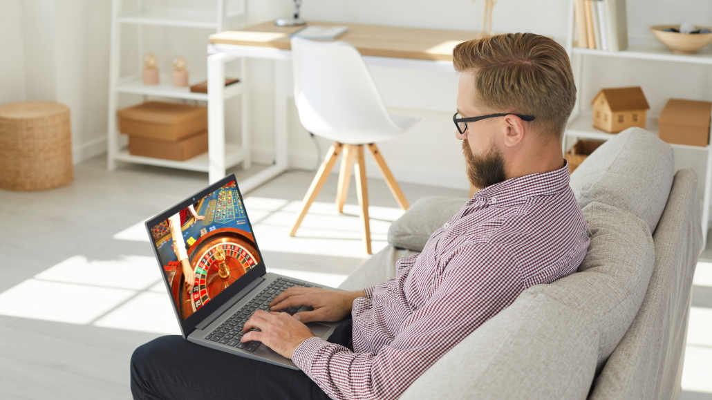 A person using a laptop to make an online payment, signifying casino deposits.