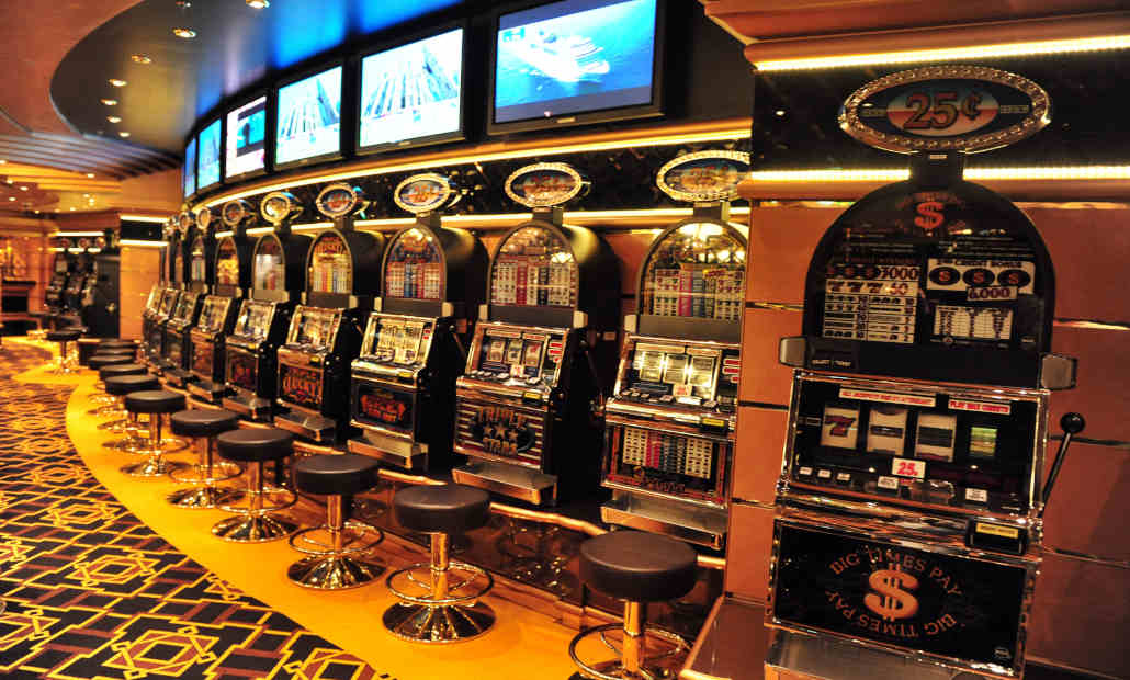 A person playing a slot machine in a bustling casino.