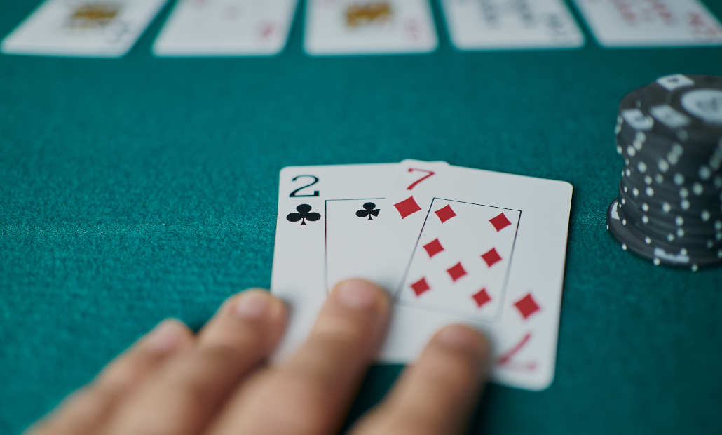 Player looking at their cards in a draw poker game.