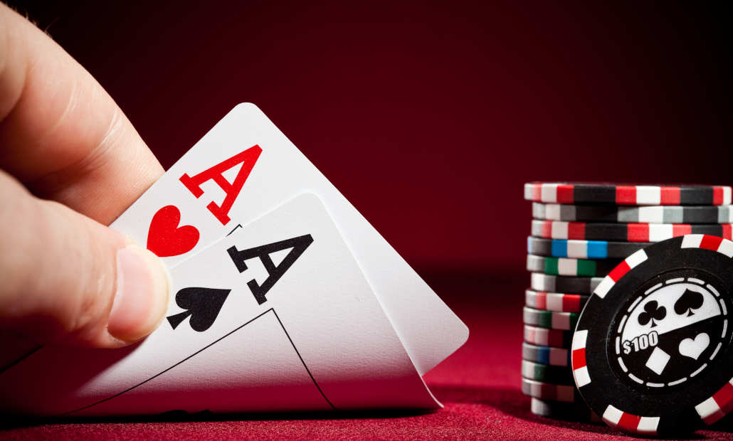 A game of Texas Hold'em in progress with chips and cards on the felt.