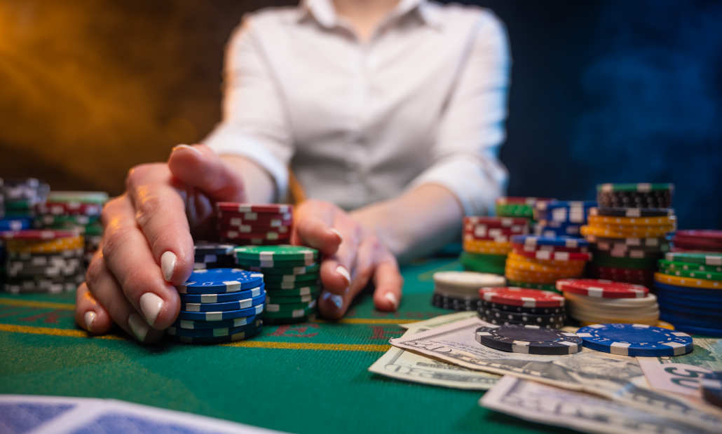 A person counting a large stack of cash on a table.
