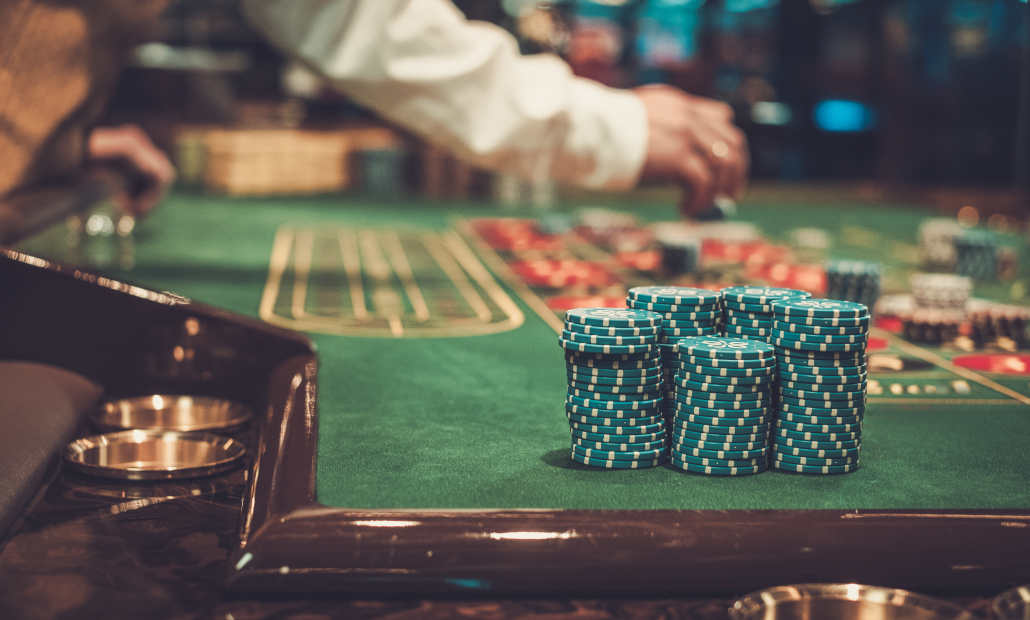 A collection of real, colorful casino chips displaying intricate designs.