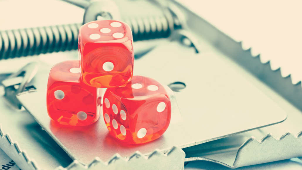 A person looking closely at a laptop screen, demonstrating how to recognize scam casino sites.