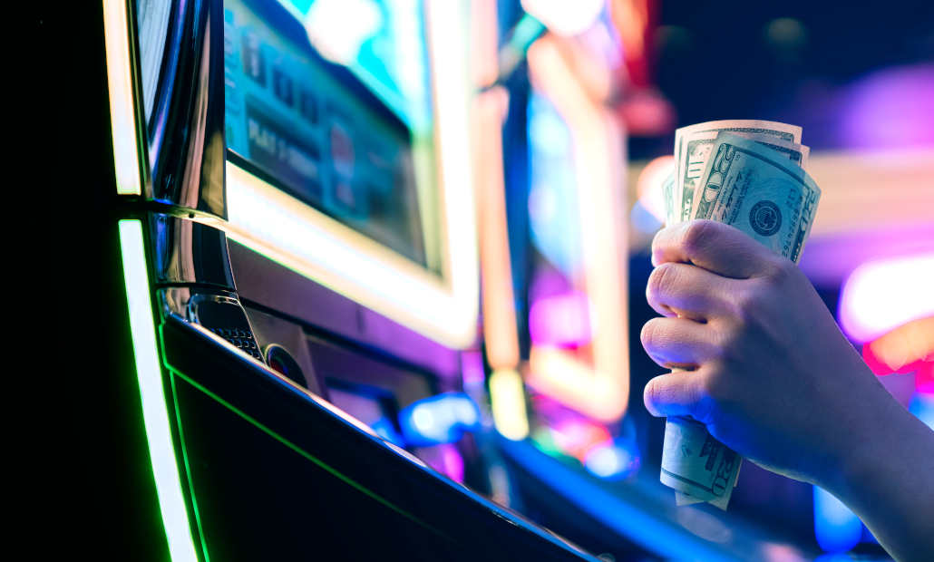 A person playing slots on a mobile device, focusing on control.