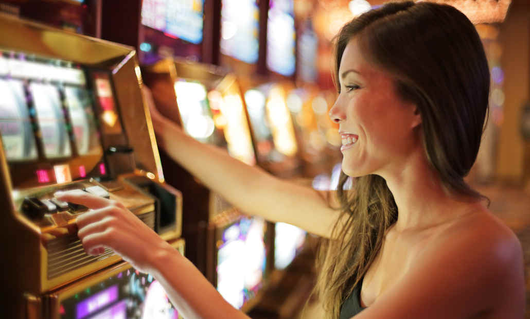 A person playing an online slot game on a laptop