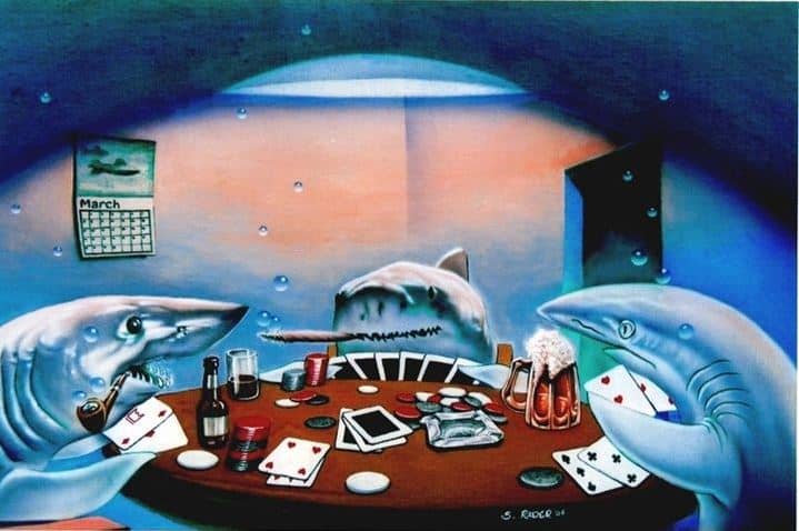 A showdown at an Ultimate Texas Hold'em table with cards revealed.