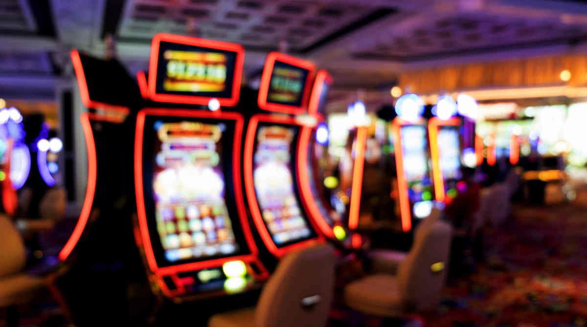 A person interacting with a futuristic digital interface representing AI in slot gaming.