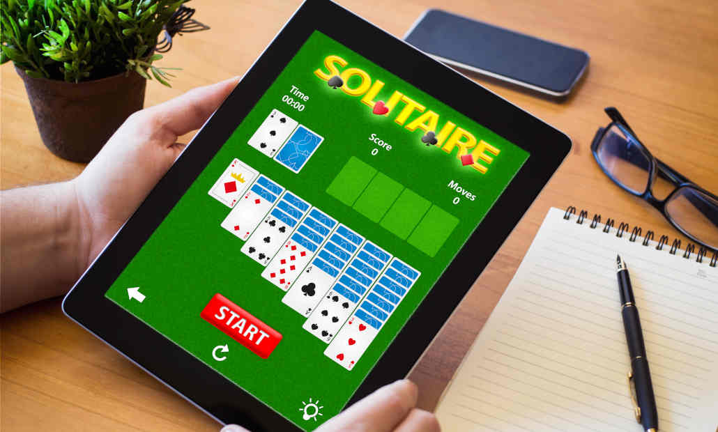 Playing cards arranged in a game of Klondike Solitaire, illustrating the rules.