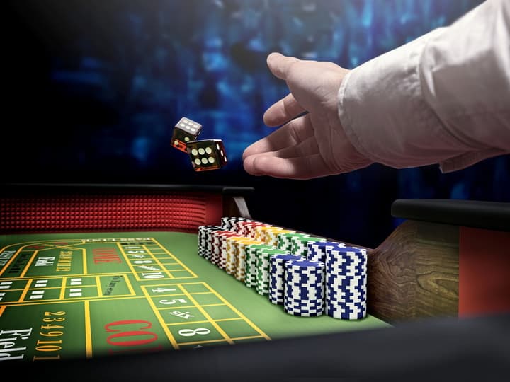 Dice being thrown on a craps table.