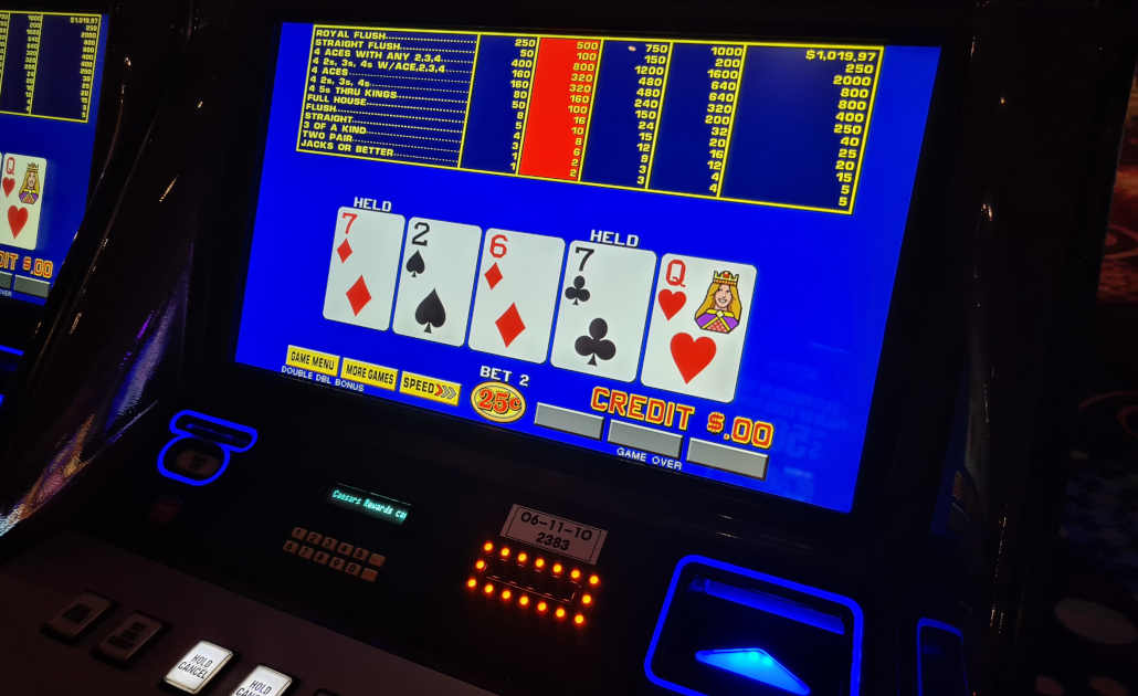 A person playing video poker on a tablet.
