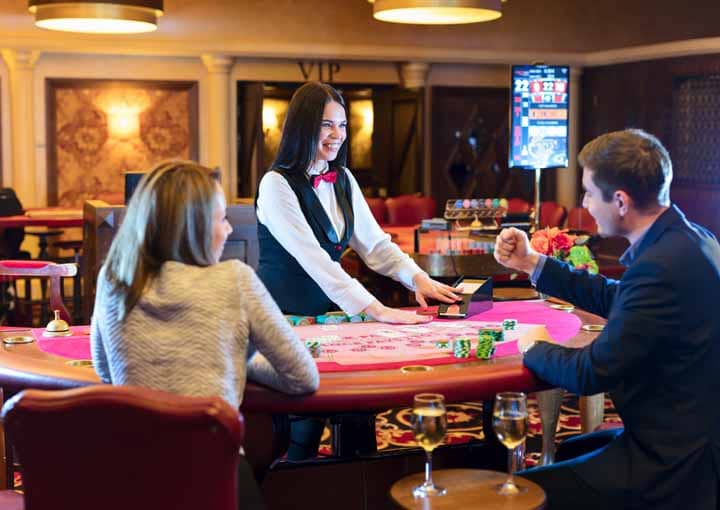 A close-up of casino chips and cards illustrating Baccarat strategy.