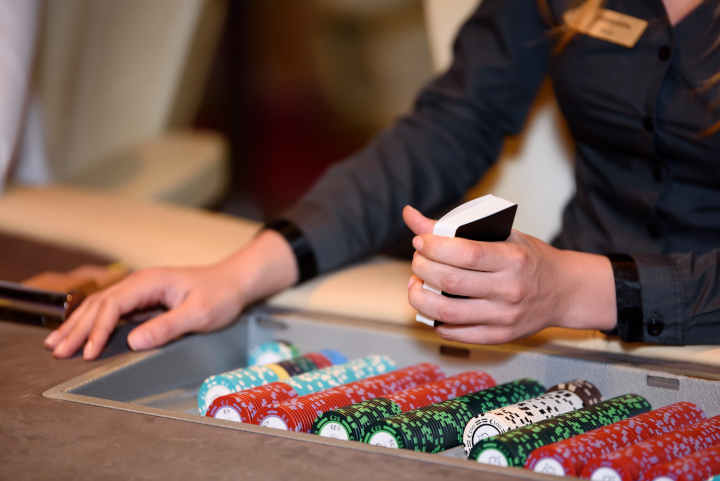 Players at a casino poker table learning etiquette