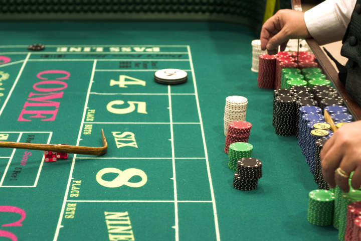 A craps table with chips indicating high betting limits.