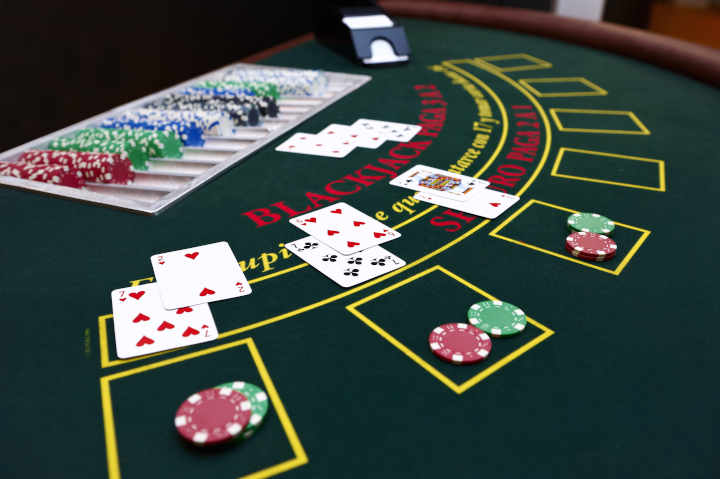 A variety of side bet options illuminated on a modern blackjack table.