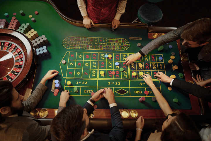 A croupier managing an American roulette table during a game.