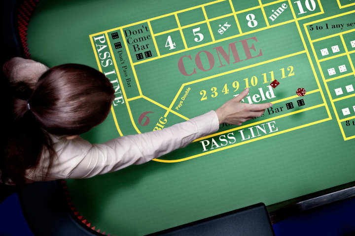 Players celebrating excitedly around a craps table.