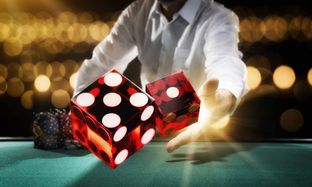 Dice being thrown on a craps table.