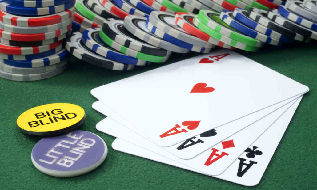 Close-up of poker chips and cards with table positions in the background.