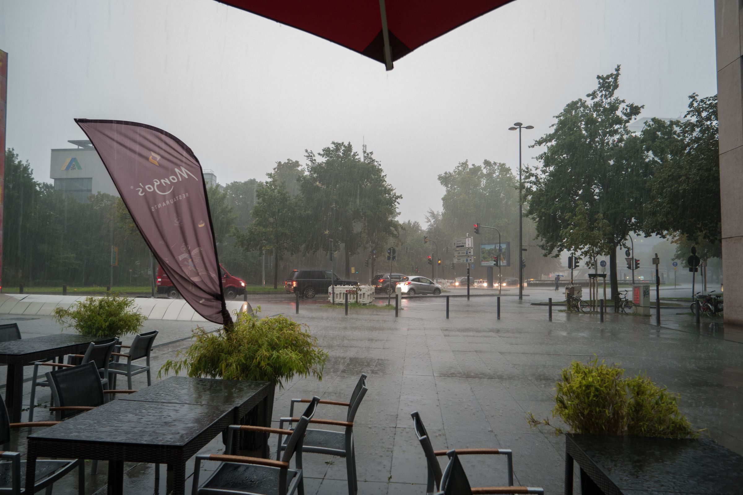 Heavy rainfall left us searching for cover under umbrellas of Mongo's Restaurant after being kicked out of the Köln Triangle lobby.