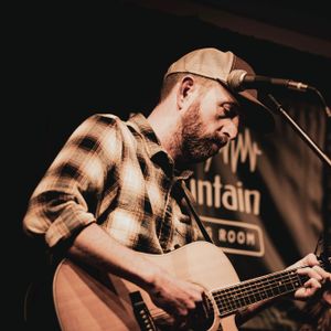 Jason Andrew Griffith playing guitar on stage