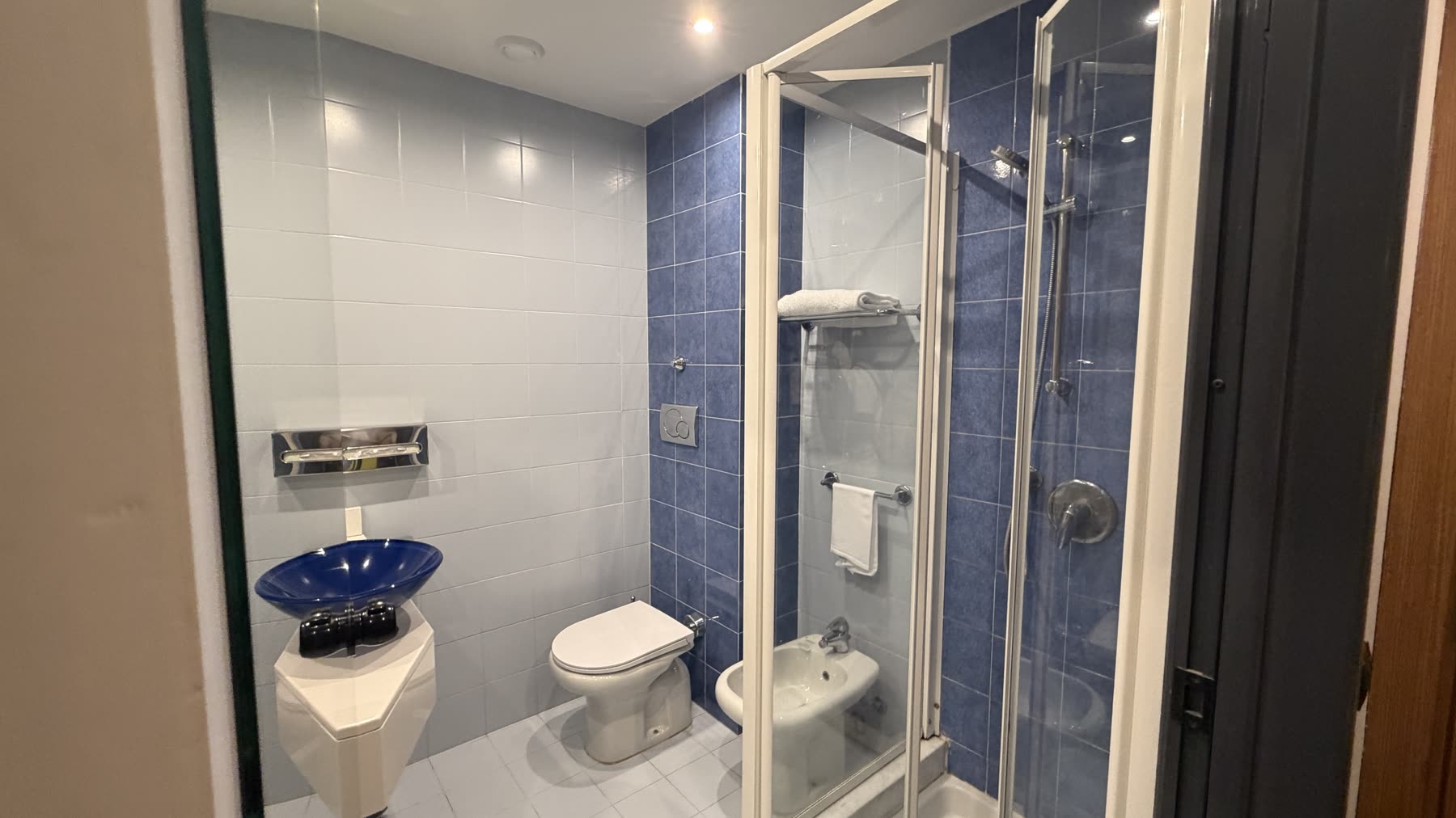 Bathroom in room 109 at Belstay Milano Linate with shower cabin, sink, toilet, and bidet