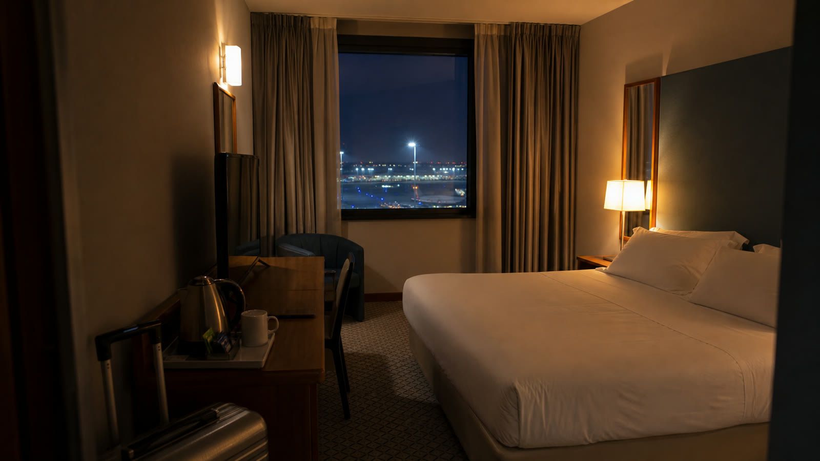 Generated editorial cover image of an airport hotel room at night, created for this Belstay Milano Linate review