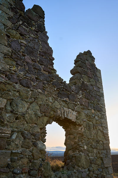 The ruins Barnes Castle in the fields of Scotland. Walls