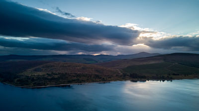 aerial photograph of a water reservoir taken at dusk with a colourful sky.