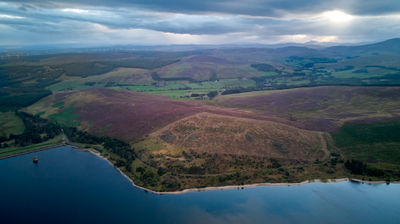 Aerial shot of a water reservoir taken at dusk and featuring a vibrant sky.