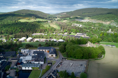 Balvenie Castle and Glenfiddich Distillery from the air. Hills in the background