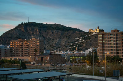Tranquil city nestled in majestic mountainscape, adorned with castles and churches. A captivating blend of history and nature at dusk. Cullera, Spain