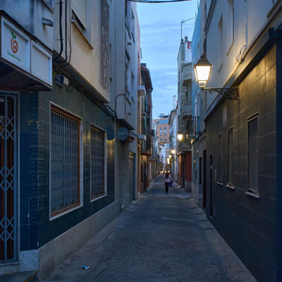 Cullera, Valencia, Spain 5.21.2023 Embrace the Mystery of the City: A woman confidently navigates the unknown, while intrigue and adventure awaits around every corner