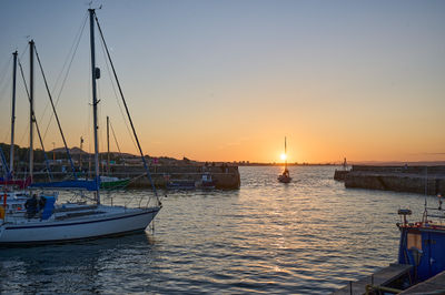 Sunset over Musselburgh harbour - a boat returning to the harbour