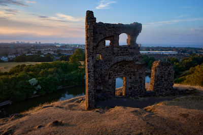 Ruin of St Anthony Chapel in summer evening. Saint Margaret's Loch below