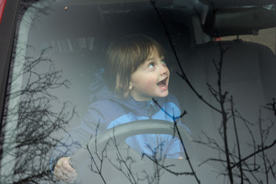 Happy Little Boy at the Wheel of the Car       