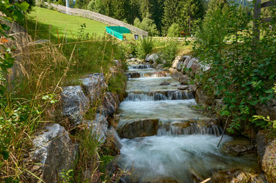 A village in Swiss Alps -  water stream