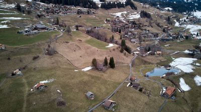 An alpine village with a small lake from the air