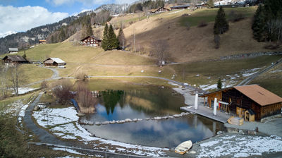 An alpine village with a small lake from the air