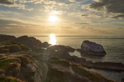 An Epic Sunset over the Sea and Rocky Shores