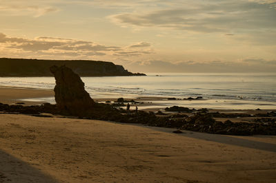 A Sunset to Take Your Breath Away: Beach, Rocks, and a beautiful sky