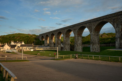 An evening in a small Scottish coastal town with a viaduct in a foreground