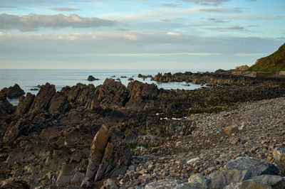 A rocky beach and the sea in the evening