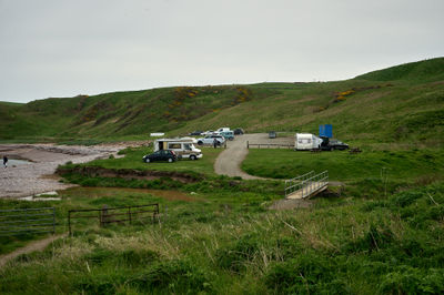 Small parking place on the seaside with parked cars and caravans