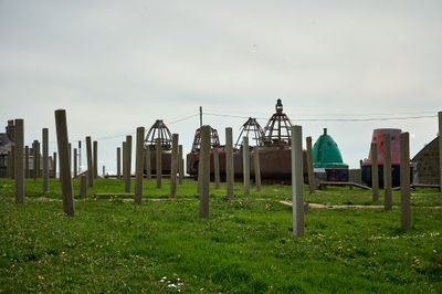 A strange landscape with posts and other metal structures on a seaside