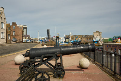 An old cannon on a street in a seaside Scottish town